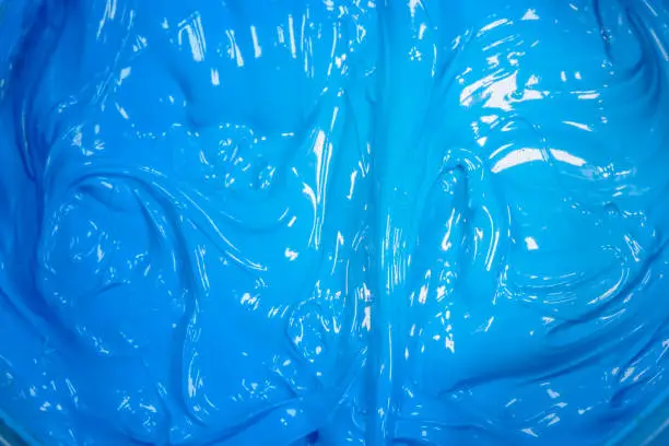 Photo of close up light blue color of oil paint.