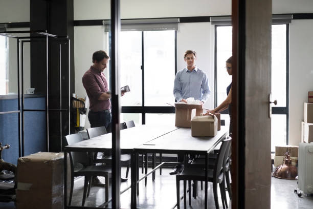istock Business people packing cardboard boxes at office 1126830102