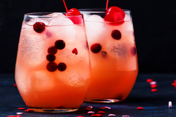 istock Festive pink cold alcoholic cocktail with red maraschino cherries for Valentines day, two glasses, 1126831432