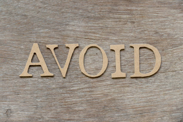 istock Alphabet letter in word avoid on wood background 1126833796