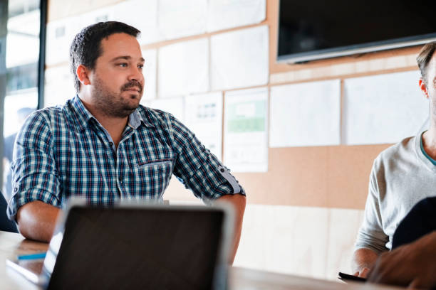 istock Businessman sitting with colleague in office 1126834897