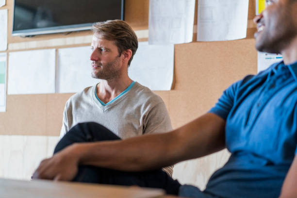 istock Thoughtful businessman with colleague in office 1126835424