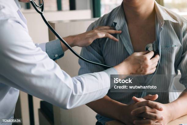 Asian Doctor Is Using A Stethoscope Listen To The Heartbeat Of The Elderly Patient Stock Photo - Download Image Now