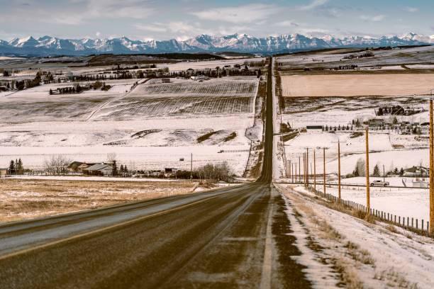 istock Rural road running through a farm landscape 1126838643