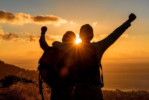 istock Rear view of hikers enjoying success on hill 1126840663