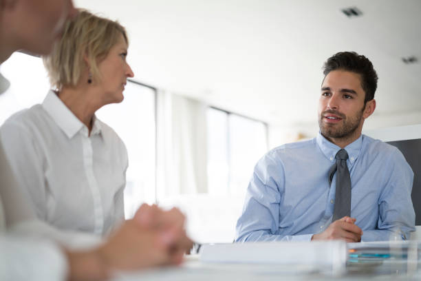 istock Businessman discussing with colleagues at desk 1126842318