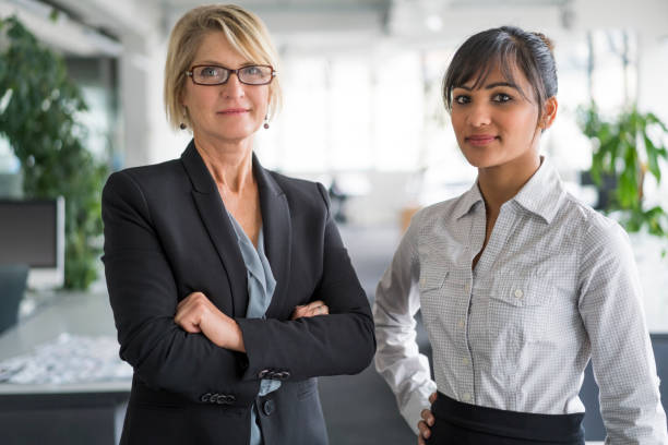 istock Confident businesswomen standing in office 1126842359