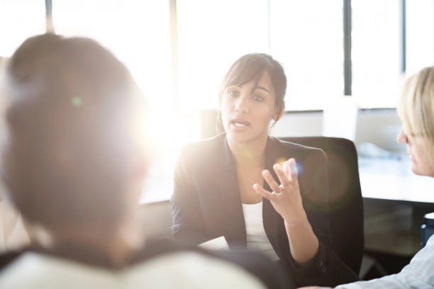 istock Businesswoman discussing with colleagues 1126843406