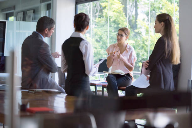 istock Businesswoman sharing ideas with colleagues 1126843851