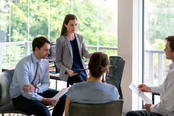 istock Confident businesswoman discussing with colleagues 1126844738