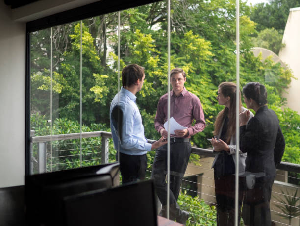 istock Business people discussing on balcony at office 1126844740