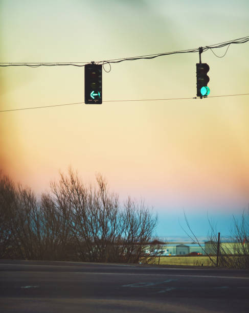 istock Traffic lights at sunset showing green signals shot through tree branches 1126845838