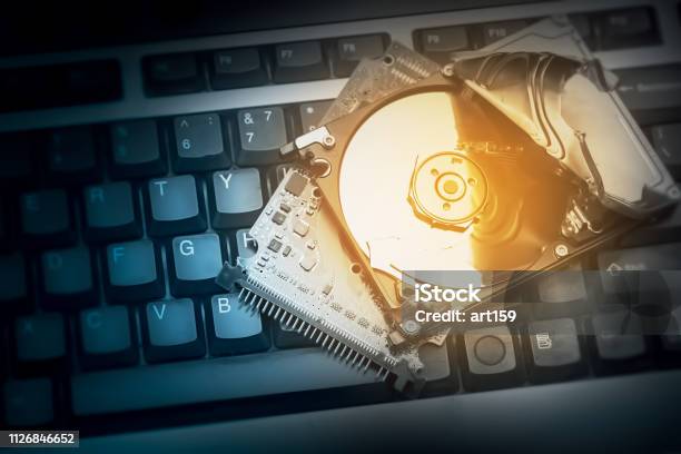 Hacked Computer Hard Drive On Keyboard Concept Of Cybercrime Stock Photo - Download Image Now