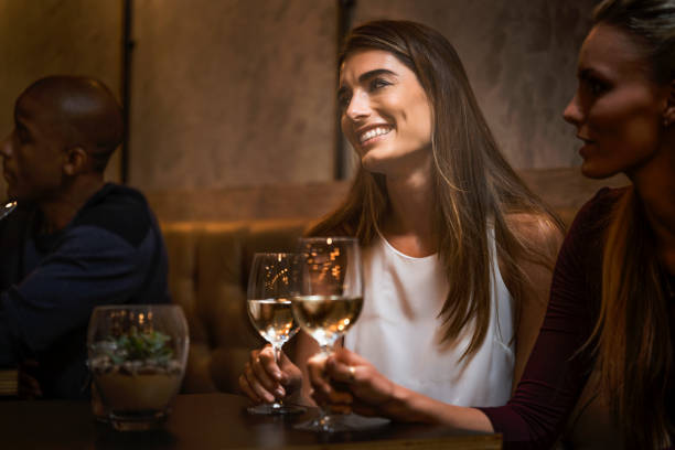 istock Female friends with wine glasses in restaurant 1126846841