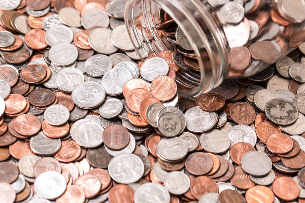 Close up of many different type of coins with jar Close up of many different type of coins with jar cent sign photos stock pictures, royalty-free photos & images