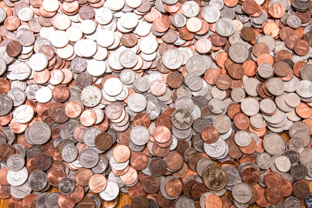 istock Close up of many different type of coins with jar 1126849175