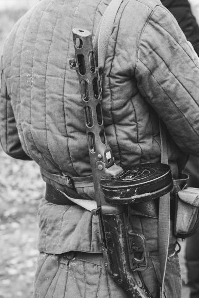 istock Soldier in a padded jacket with a gun ppsh 1126850831