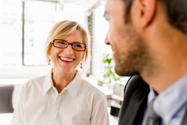 istock Female manager talking with businessman in office 1126850851