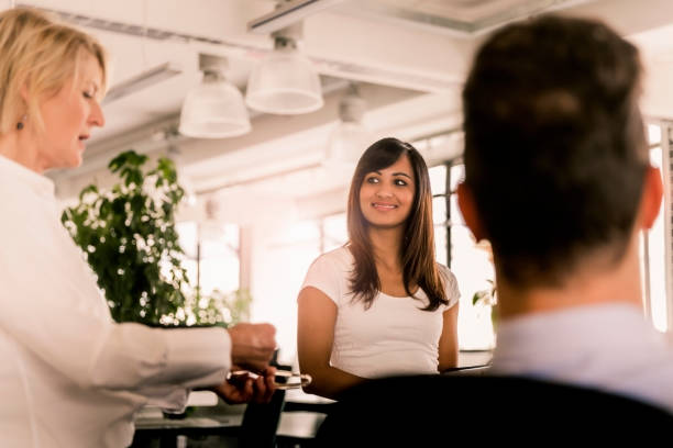 istock Mature female manager planning with colleagues 1126851032