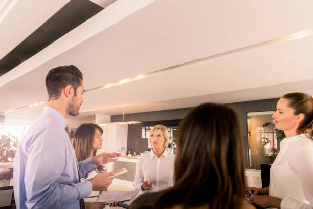 istock Businessman discussing with female colleagues 1126851162