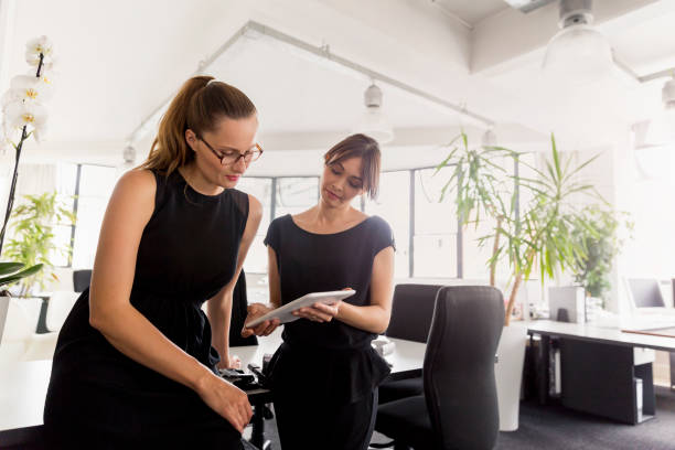 istock Businesswoman with colleague using digital tablet 1126852046