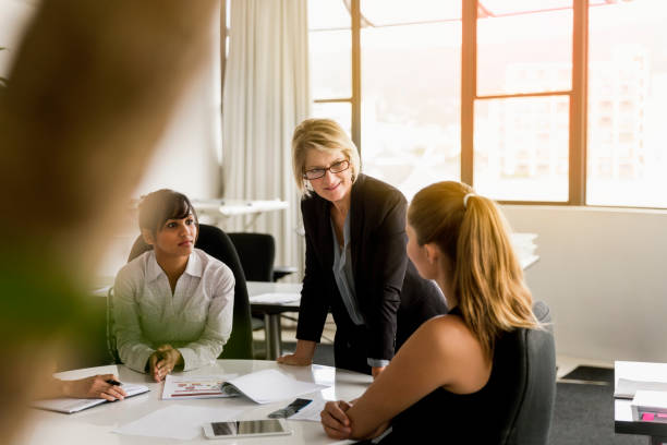 istock Female manager interacting with coworker in office 1126852154