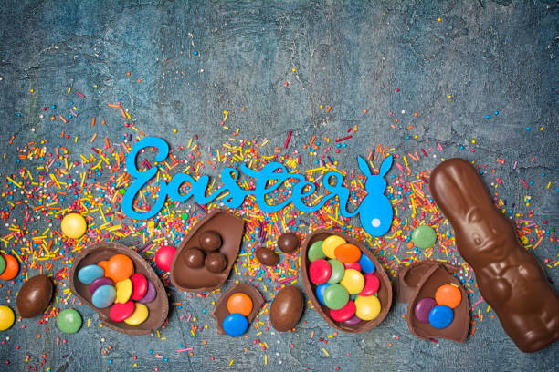 istock Top view on bright text of easter with chocolate traditional eggs, bunny and sprinkles 1126855684