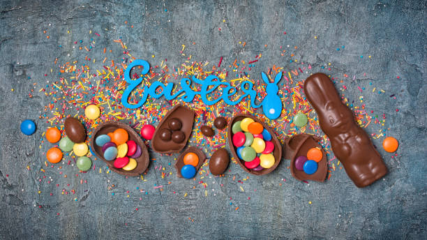 istock Top view on bright text of easter with chocolate traditional eggs, bunny and sprinkles 1126855686