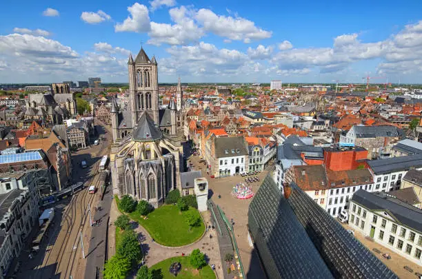 Photo of Aerial view of Ghent from Belfry. Saint Nicholas' Church and beautiful medieval buildings. Spring landscape photo. Selective focus with wide angle lens