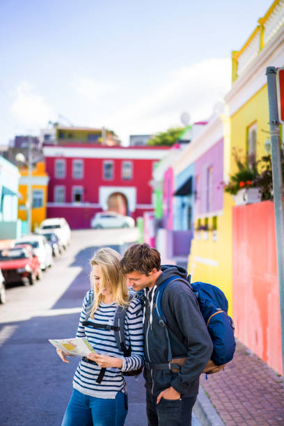 istock Young couple reading map on street 1126858283