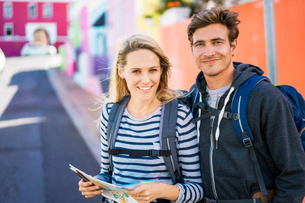 istock Young couple reading map on street 1126858284
