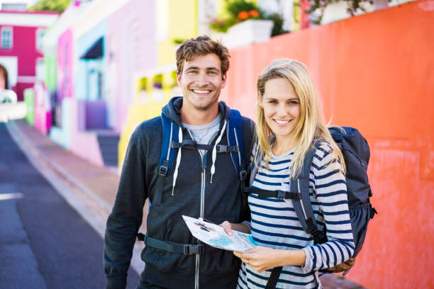 istock Portrait of happy backpackers outside building 1126858306