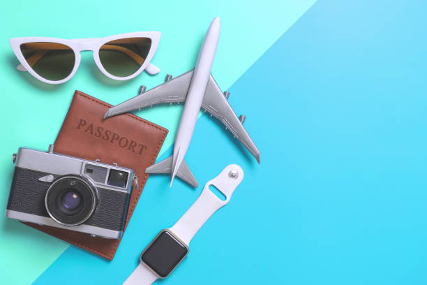 istock Travel accessories objects and gadgets top view flatlay on blue and teal 1126860130