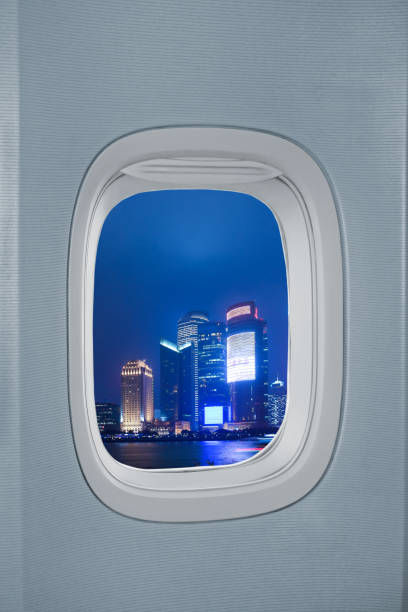 istock Airplane window with city skyline scene 1126861494