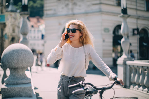 istock Woman with bicycle in the city 1126863619