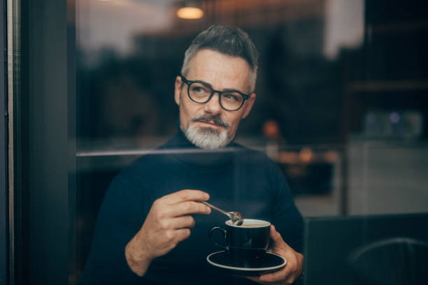 istock Mature man in the coffee shop 1126866275