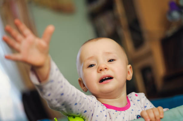 istock pretty pathetic sad child standing in playpen 1126866470
