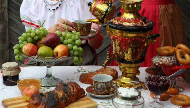 Still life with a samovar, tea and sweet pastries stock photo