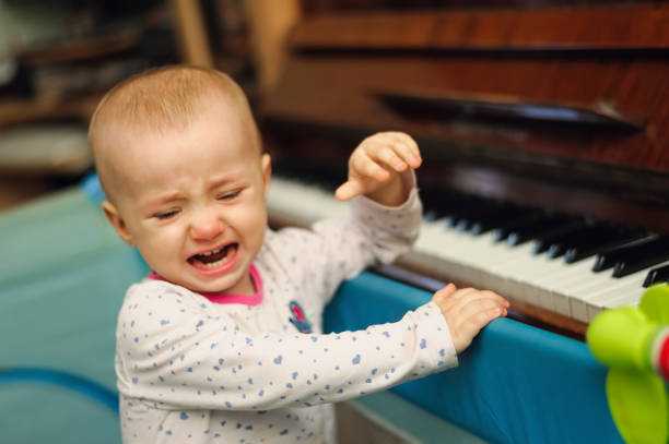 istock tearful child standing in playpen 1126867190