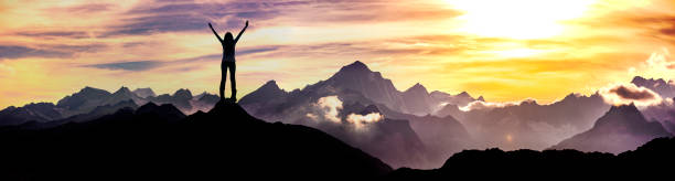 Woman at a summit in sunset Woman standing at a summit switzerland photos stock pictures, royalty-free photos & images