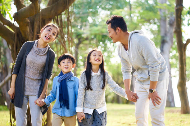 istock asian family having fun in park 1126867264