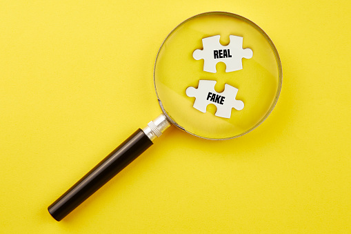 Search right puzzle piece with magnifying glass standing on yellow background.
