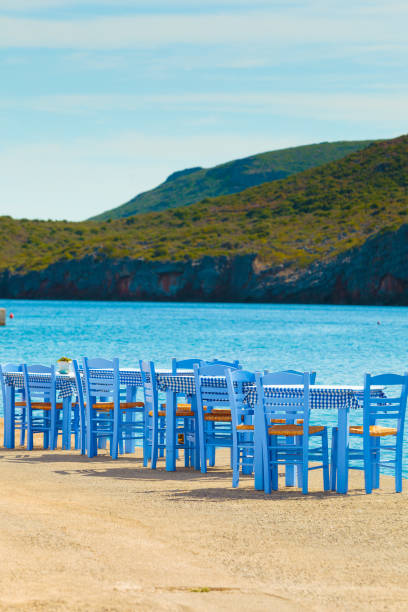 istock Open cafe outdoor restaurant in Greece on sea shore 1126869777