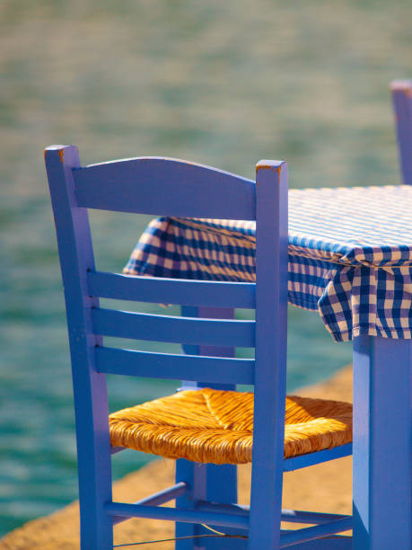 istock Open cafe outdoor restaurant in Greece on sea shore 1126869791