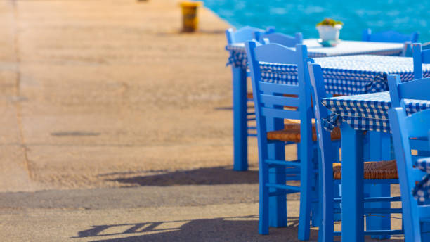 istock Open cafe outdoor restaurant in Greece on sea shore 1126869801