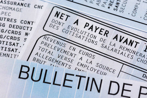 French payroll with income tax deduction Close up on a french payroll with social contributions and income tax deduction, mandatory in France since January 2019 minimum wage stock pictures, royalty-free photos & images