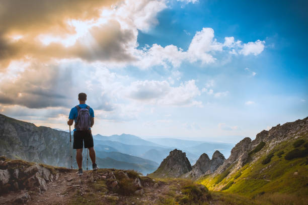 istock man on the top of a rock 1126874656