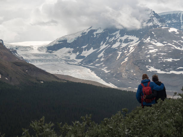 istock Happy couple looking at Atabasca glacier 1126875614