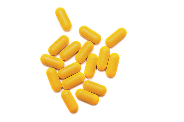 istock many large yellow pills on white background 1126876025