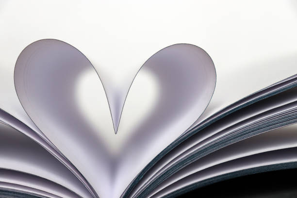 istock Heart shape from paper book pages isolated on white background 1126876628